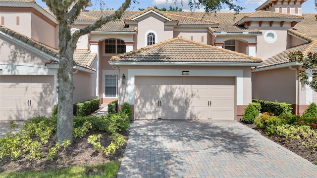 8401 Riverdale Ln Unit 8401, Davenport, FL 33896 - mediterranean / spanish-style home featuring a tile roof, stucco siding, a garage, and driveway