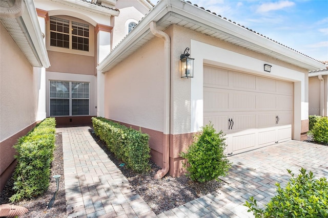 8401 Riverdale Ln Unit 8401, Davenport, FL 33896 - property entrance with stucco siding, a garage, and driveway