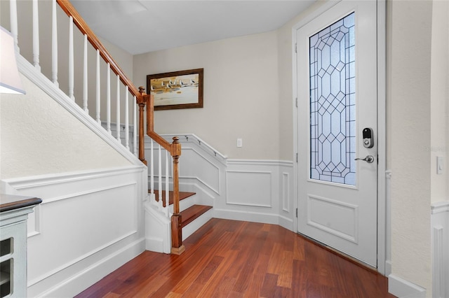 8401 Riverdale Ln Unit 8401, Davenport, FL 33896 - foyer with dark wood-style floors, stairway, a wainscoted wall, and a decorative wall