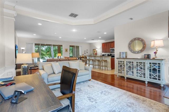 8401 Riverdale Ln Unit 8401, Davenport, FL 33896 - living area with wood finished floors, ornamental molding, recessed lighting, a wainscoted wall, and a tray ceiling