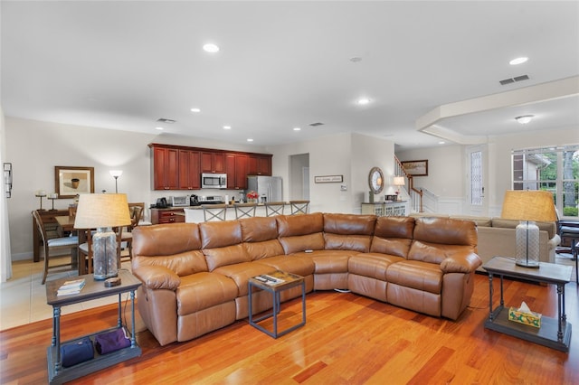 8401 Riverdale Ln Unit 8401, Davenport, FL 33896 - living room featuring light wood-style flooring, wainscoting, recessed lighting, and a decorative wall