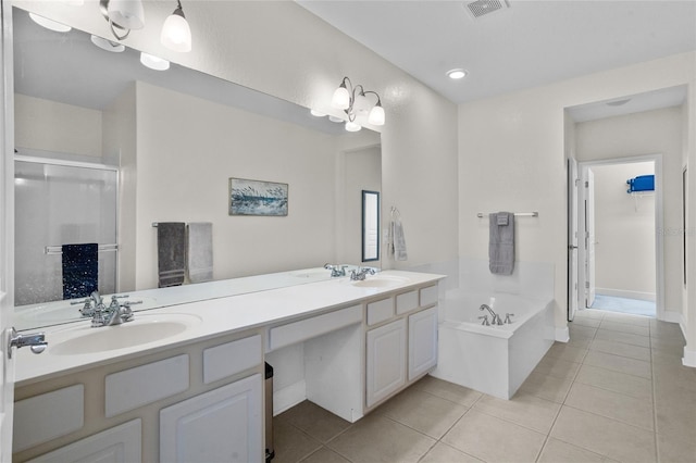 8401 Riverdale Ln Unit 8401, Davenport, FL 33896 - bathroom with tile patterned floors, a garden tub, double vanity, a shower stall, and recessed lighting