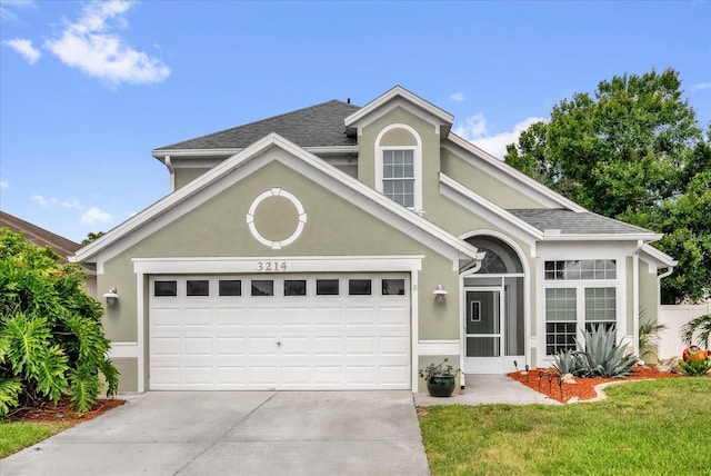 3214 Herons Point Cir, Kissimmee, FL 34741 - traditional home with driveway, a garage, stucco siding, a front lawn, and a shingled roof