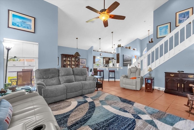 3214 Herons Point Cir, Kissimmee, FL 34741 - tiled living room featuring high vaulted ceiling, stairs, and ceiling fan