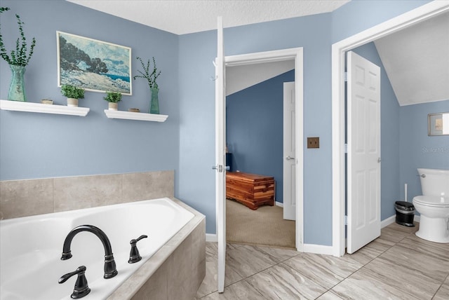 3214 Herons Point Cir, Kissimmee, FL 34741 - bathroom with a bath and vaulted ceiling