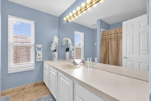 3214 Herons Point Cir, Kissimmee, FL 34741 - bathroom featuring vanity, a textured ceiling, and tile patterned flooring
