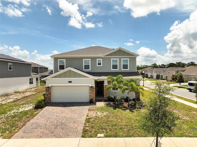 2759 Slash Way, Saint Cloud, FL 34771 - view of front facade with board and batten siding, decorative driveway, a garage, a shingled roof, and a residential view