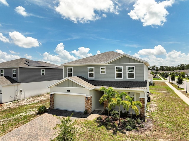 2759 Slash Way, Saint Cloud, FL 34771 - view of front of house featuring board and batten siding, decorative driveway, roof with shingles, and a garage