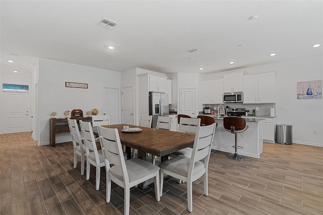 2759 Slash Way, Saint Cloud, FL 34771 - dining space with light wood-style floors and recessed lighting