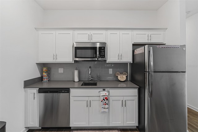 2759 Slash Way, Saint Cloud, FL 34771 - kitchen featuring stainless steel appliances, white cabinets, dark countertops, and backsplash