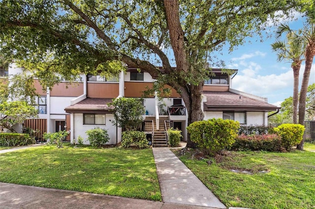 4570 Tower Pine Rd Ge, Unit Ge, Orlando, FL 32839 - view of property featuring stairway and stucco siding