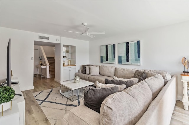 4570 Tower Pine Rd Ge, Unit Ge, Orlando, FL 32839 - living area featuring a ceiling fan, light wood finished floors, and stairway