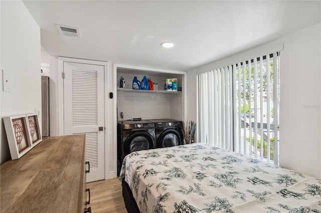4570 Tower Pine Rd Ge, Unit Ge, Orlando, FL 32839 - bedroom featuring independent washer and dryer, light wood-type flooring, and access to outside