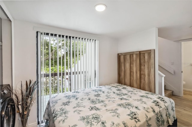 4570 Tower Pine Rd Ge, Unit Ge, Orlando, FL 32839 - bedroom featuring wood finished floors and washer / clothes dryer