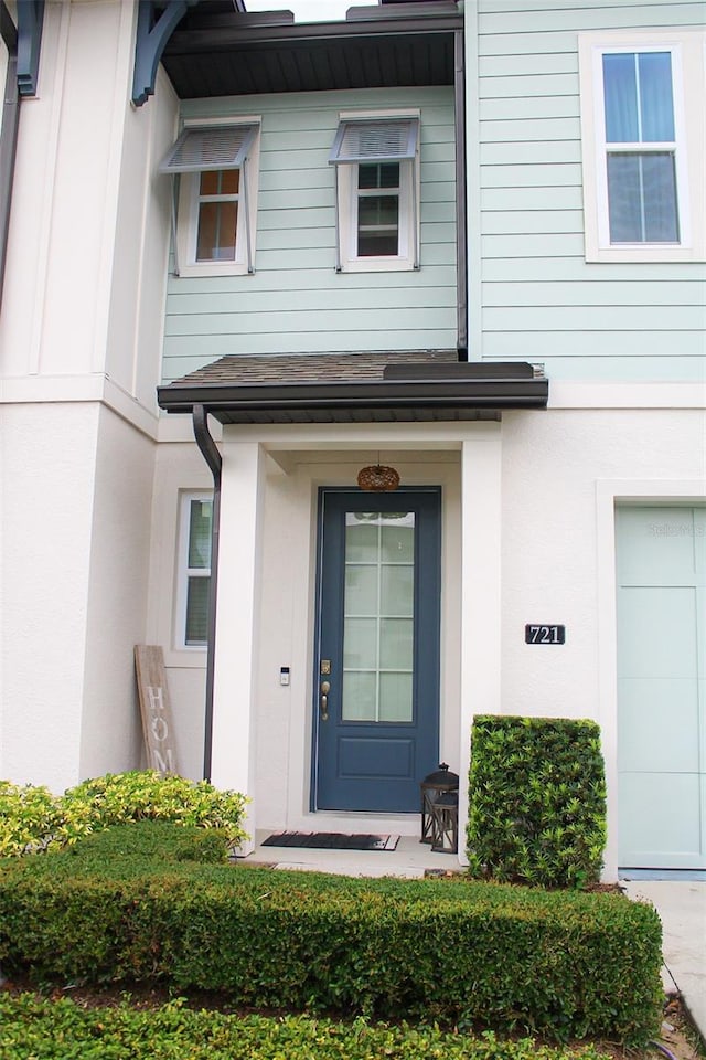 721 Benoi Dr, Davenport, FL 33896 - entrance to property featuring stucco siding and a garage