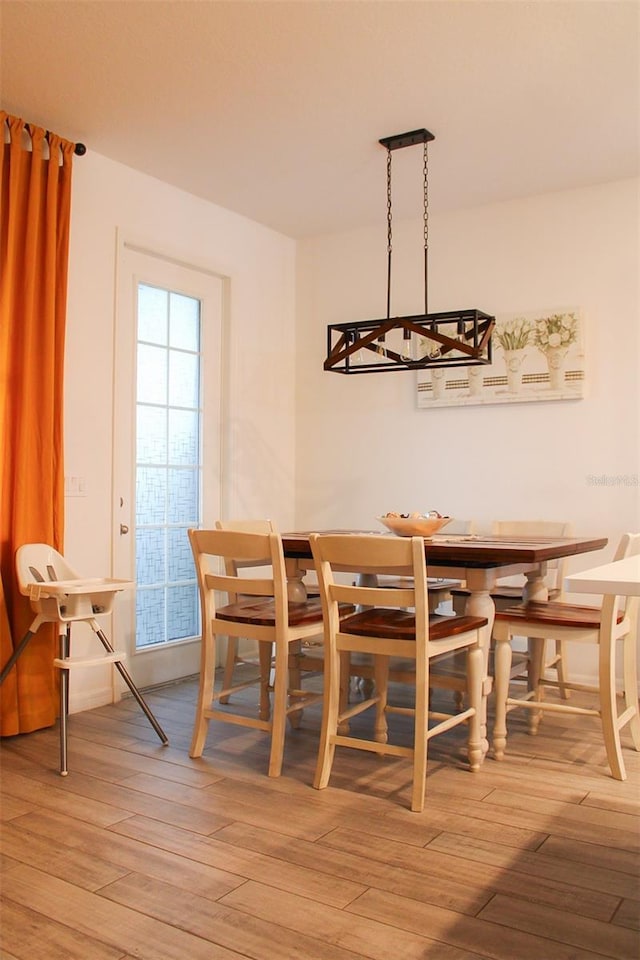 721 Benoi Dr, Davenport, FL 33896 - dining room featuring a chandelier and hardwood / wood-style floors