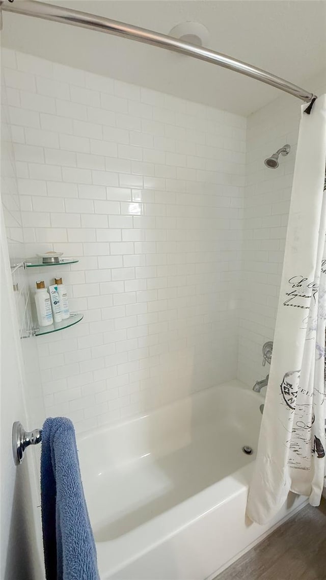 721 Benoi Dr, Davenport, FL 33896 - full bathroom with shower / tub combo and wood finished floors