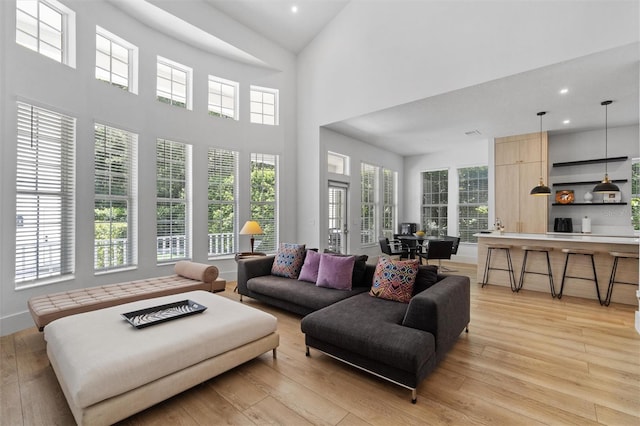 933 Jasmine St, Celebration, FL 34747 - living area with recessed lighting, light wood-type flooring, and a high ceiling