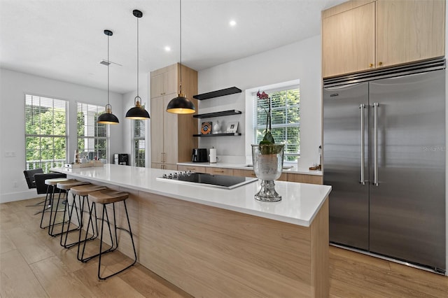 933 Jasmine St, Celebration, FL 34747 - kitchen featuring stainless steel built in refrigerator, black electric stovetop, modern cabinets, light brown cabinets, and recessed lighting