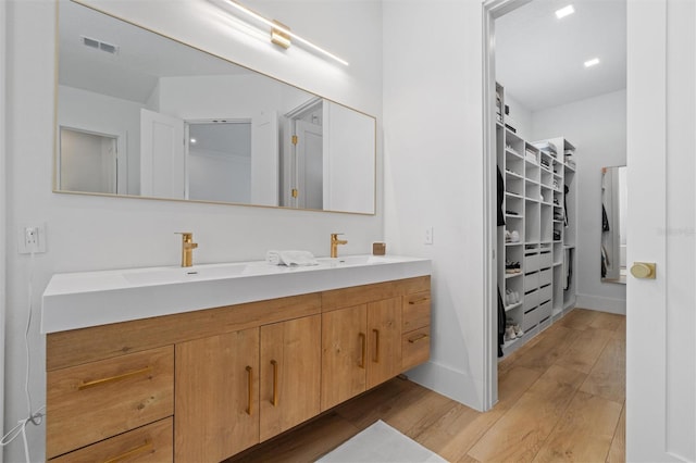 933 Jasmine St, Celebration, FL 34747 - full bathroom with double vanity, wood finished floors, and a spacious closet