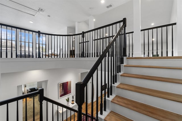 933 Jasmine St, Celebration, FL 34747 - staircase with wood finished floors, recessed lighting, and a high ceiling