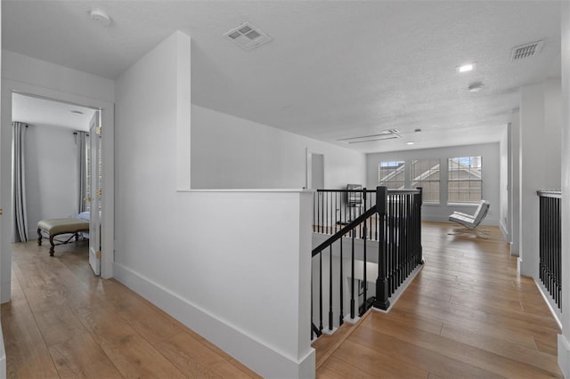 933 Jasmine St, Celebration, FL 34747 - hall with an upstairs landing, hardwood / wood-style flooring, and a textured ceiling
