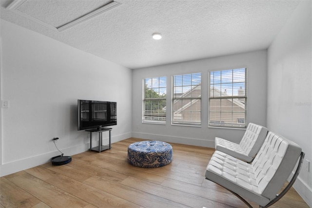933 Jasmine St, Celebration, FL 34747 - living area with a textured ceiling, healthy amount of natural light, and wood finished floors