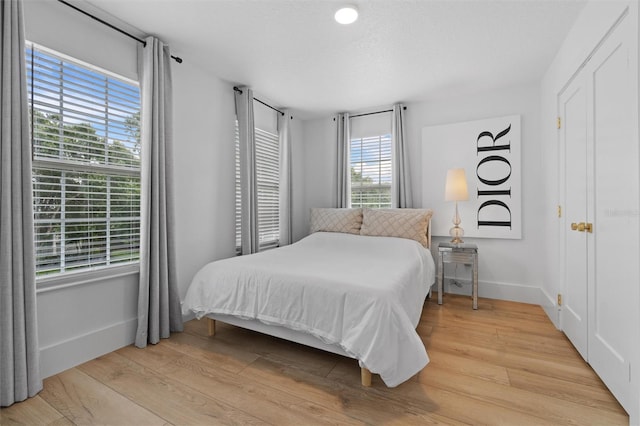 933 Jasmine St, Celebration, FL 34747 - bedroom featuring baseboards and wood finished floors