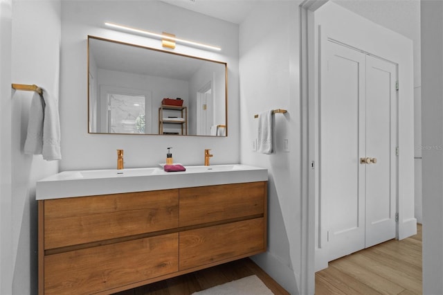933 Jasmine St, Celebration, FL 34747 - bathroom featuring double vanity and wood finished floors