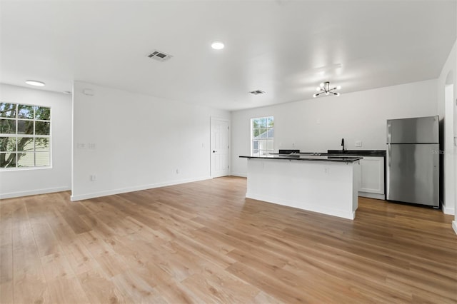 933 Jasmine St, Celebration, FL 34747 - kitchen with freestanding refrigerator, dark countertops, light wood-type flooring, open floor plan, and recessed lighting