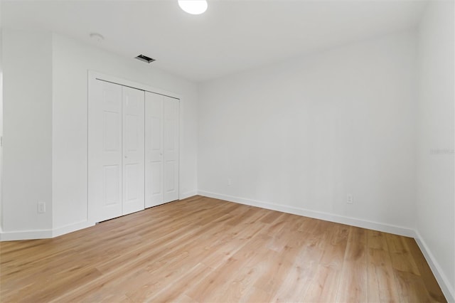 933 Jasmine St, Celebration, FL 34747 - unfurnished bedroom with light wood-type flooring and a closet