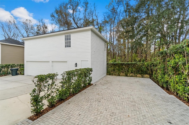 933 Jasmine St, Celebration, FL 34747 - view of side of home with decorative driveway and an attached garage