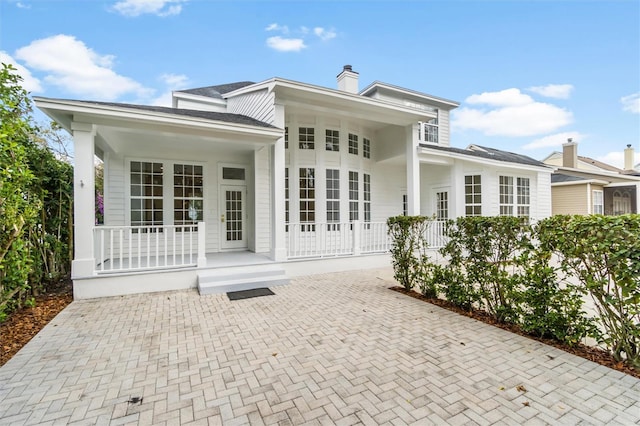 933 Jasmine St, Celebration, FL 34747 - back of property featuring a porch and a chimney