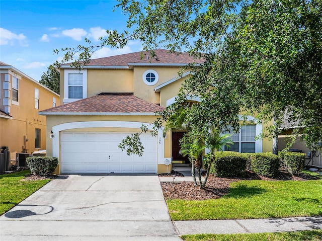 195 Hideaway Beach Ln, Kissimmee, FL 34746 - view of front facade featuring stucco siding, a shingled roof, an attached garage, and driveway