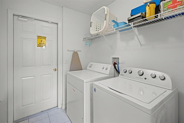 195 Hideaway Beach Ln, Kissimmee, FL 34746 - laundry area featuring washer and dryer and light tile patterned floors