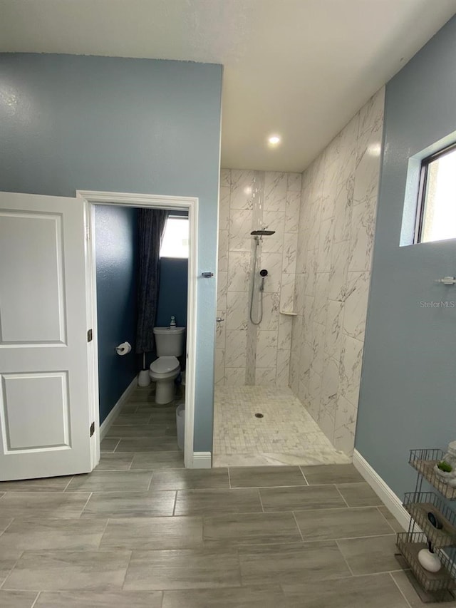 2408 Conroy Ave N, Lehigh Acres, FL 33971 - full bathroom featuring tiled shower, healthy amount of natural light, recessed lighting, and wood tiled floors