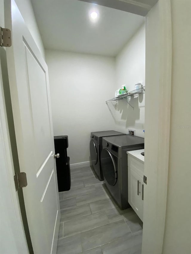 2408 Conroy Ave N, Lehigh Acres, FL 33971 - washroom featuring independent washer and dryer, cabinet space, and recessed lighting