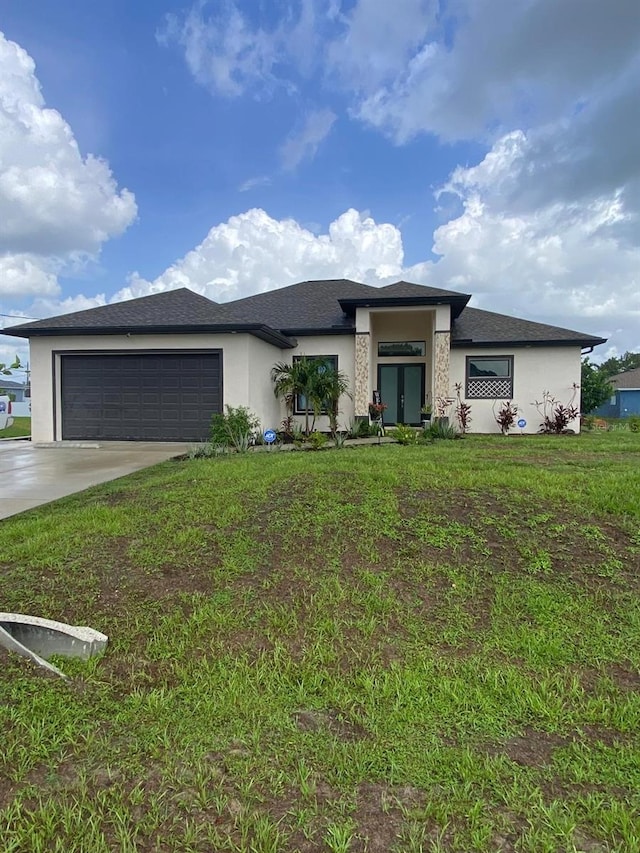 2408 Conroy Ave N, Lehigh Acres, FL 33971 - prairie-style house featuring stucco siding, a garage, driveway, and a front lawn