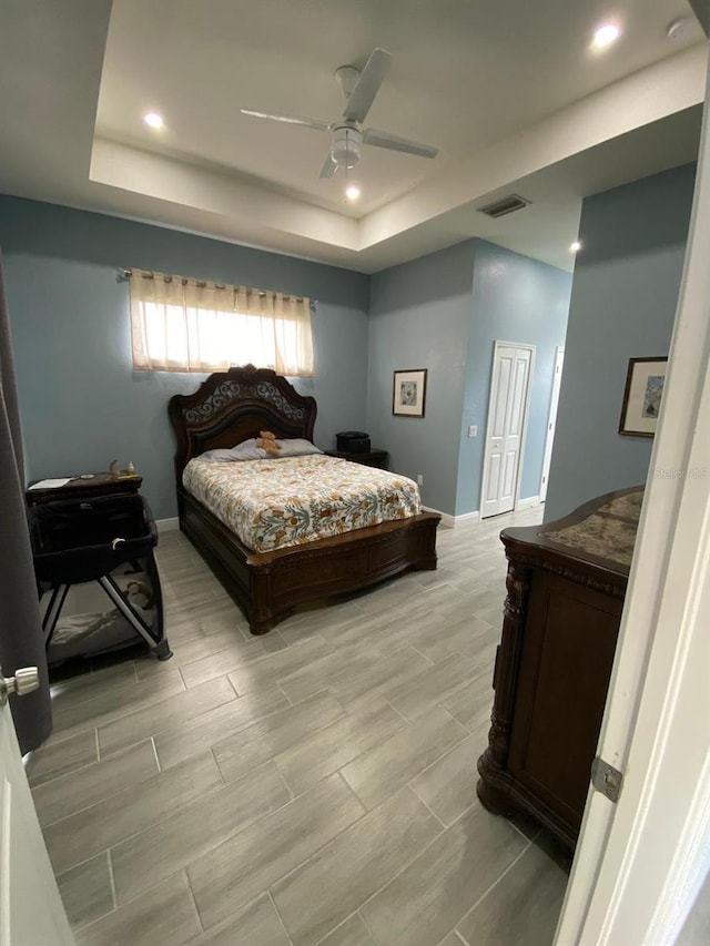 2408 Conroy Ave N, Lehigh Acres, FL 33971 - bedroom with a raised ceiling, recessed lighting, wood tiled floors, and a ceiling fan