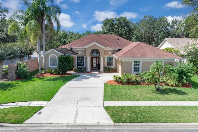 2402 Raven Croft Ct, Orlando, FL 32837 - mediterranean / spanish home featuring stucco siding, driveway, roof with shingles, and an attached garage