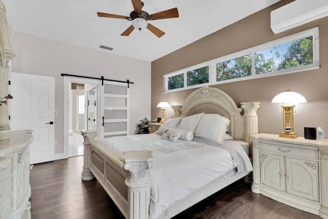 2402 Raven Croft Ct, Orlando, FL 32837 - bedroom with a barn door, a wall mounted air conditioner, dark wood-type flooring, and ceiling fan