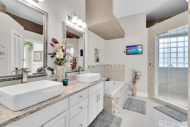 2402 Raven Croft Ct, Orlando, FL 32837 - full bath featuring a garden tub, tile patterned flooring, double vanity, and a stall shower