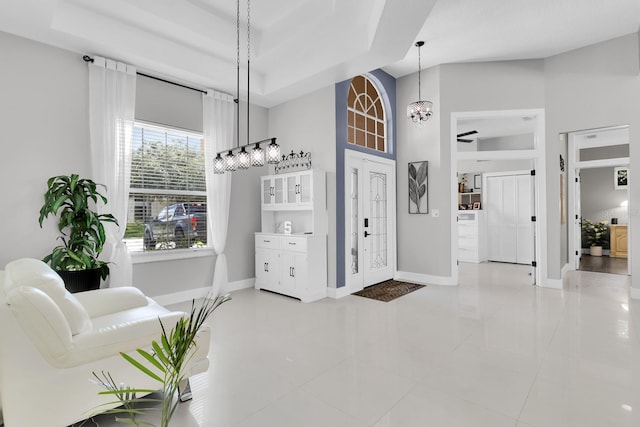 2402 Raven Croft Ct, Orlando, FL 32837 - entryway featuring a high ceiling, tile patterned floors, a chandelier, and a tray ceiling