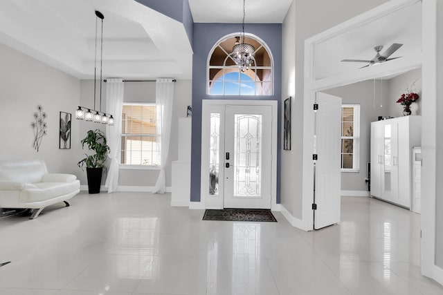 2402 Raven Croft Ct, Orlando, FL 32837 - entryway featuring tile patterned floors, a chandelier, and a ceiling fan