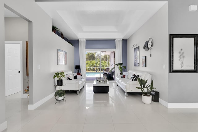 2402 Raven Croft Ct, Orlando, FL 32837 - tiled living area featuring a tray ceiling and baseboards