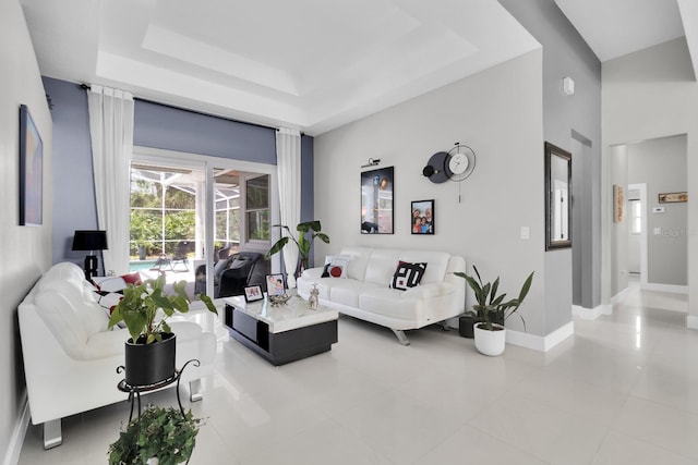 2402 Raven Croft Ct, Orlando, FL 32837 - living room with light tile patterned floors, a raised ceiling, and a high ceiling