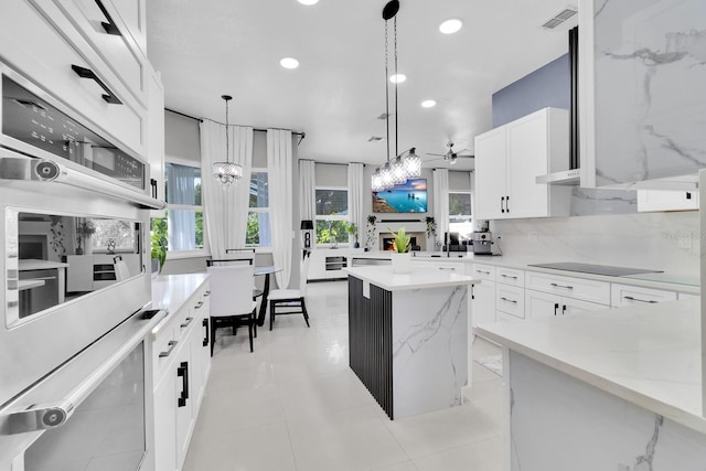 2402 Raven Croft Ct, Orlando, FL 32837 - kitchen featuring a kitchen island, white double oven, recessed lighting, a chandelier, and decorative light fixtures