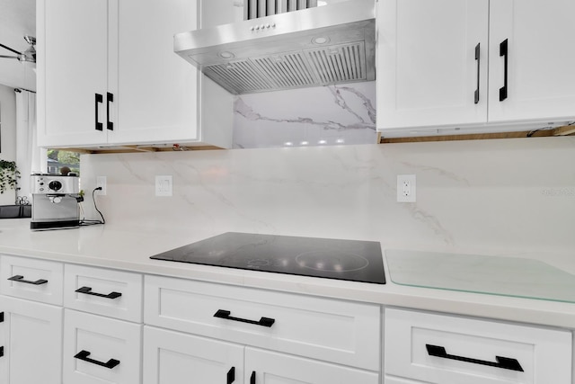 2402 Raven Croft Ct, Orlando, FL 32837 - kitchen featuring under cabinet range hood, black electric cooktop, tasteful backsplash, and light countertops