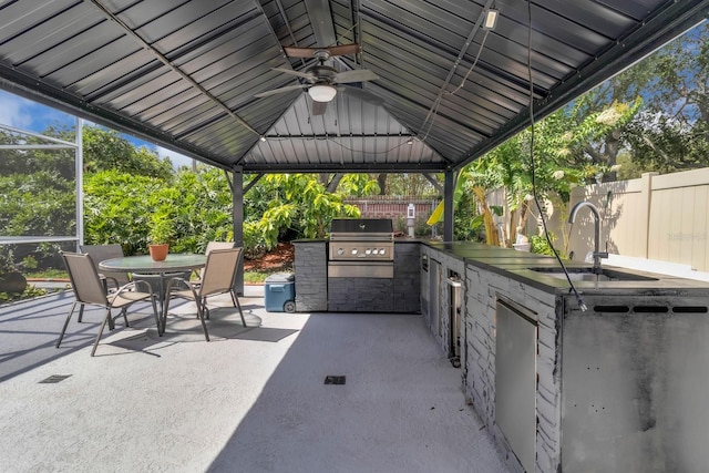 2402 Raven Croft Ct, Orlando, FL 32837 - fenced backyard with a gazebo, an outdoor kitchen, a patio, outdoor dining space, and ceiling fan