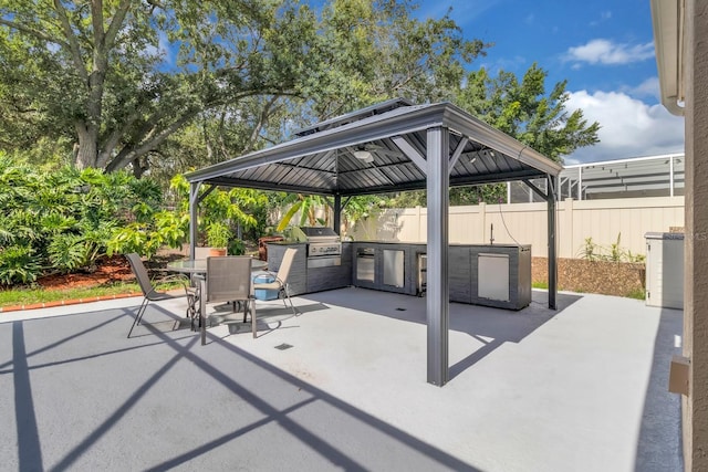 2402 Raven Croft Ct, Orlando, FL 32837 - view of patio with an outdoor kitchen, a gazebo, and outdoor dining space